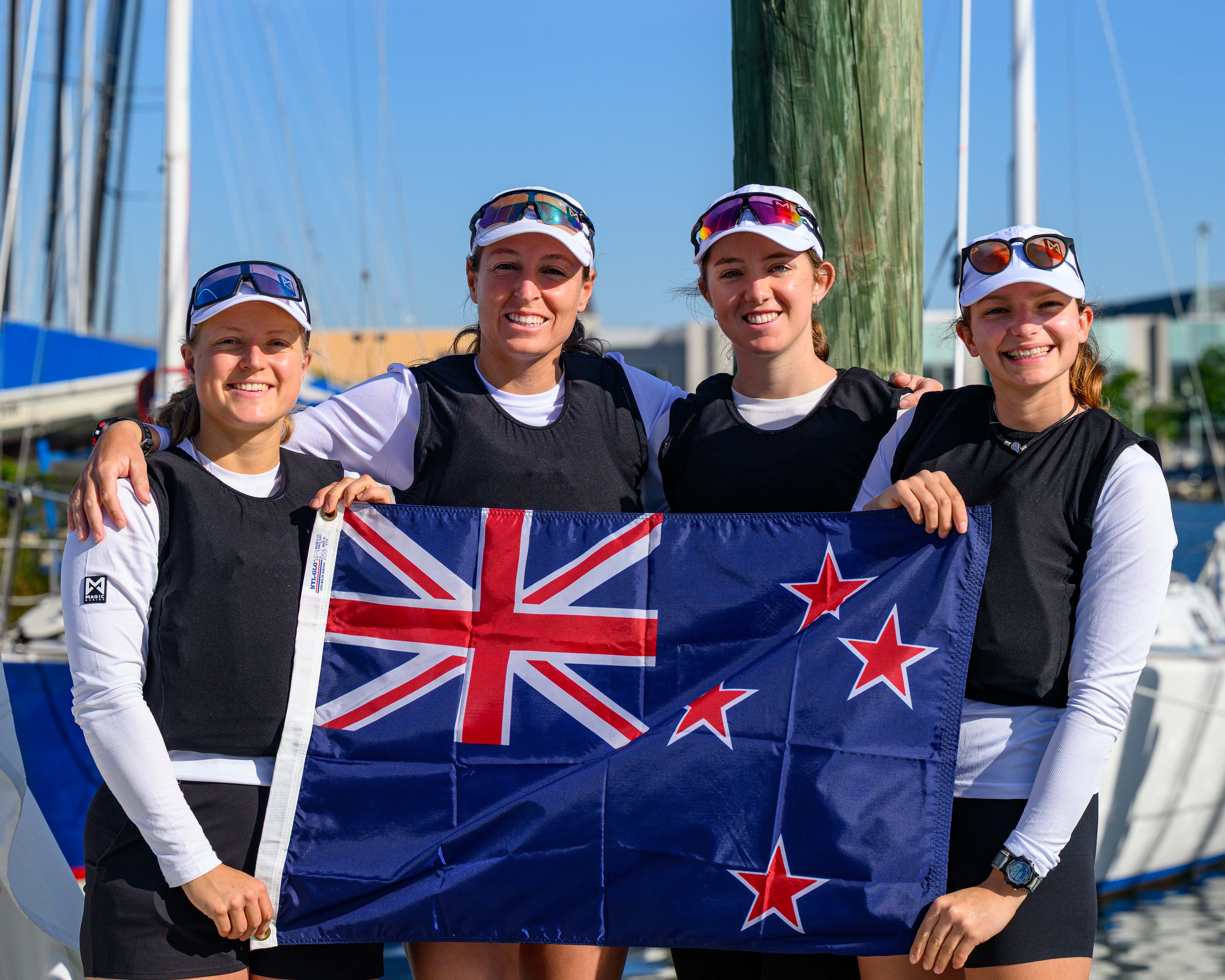 Team holding the New Zealand flag